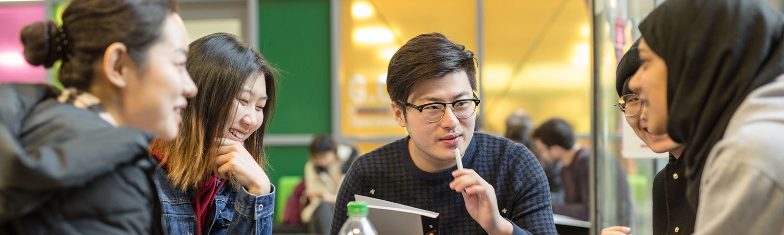 Five students are in deep conversation over their studies