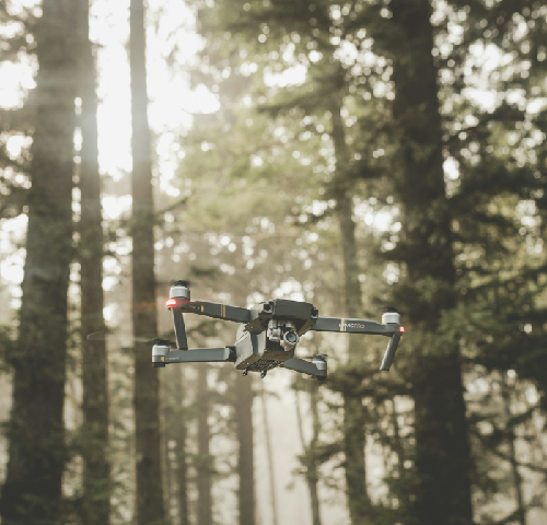 A drone flying through a forest