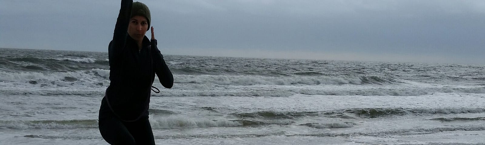 Woman with four dogs at the beach