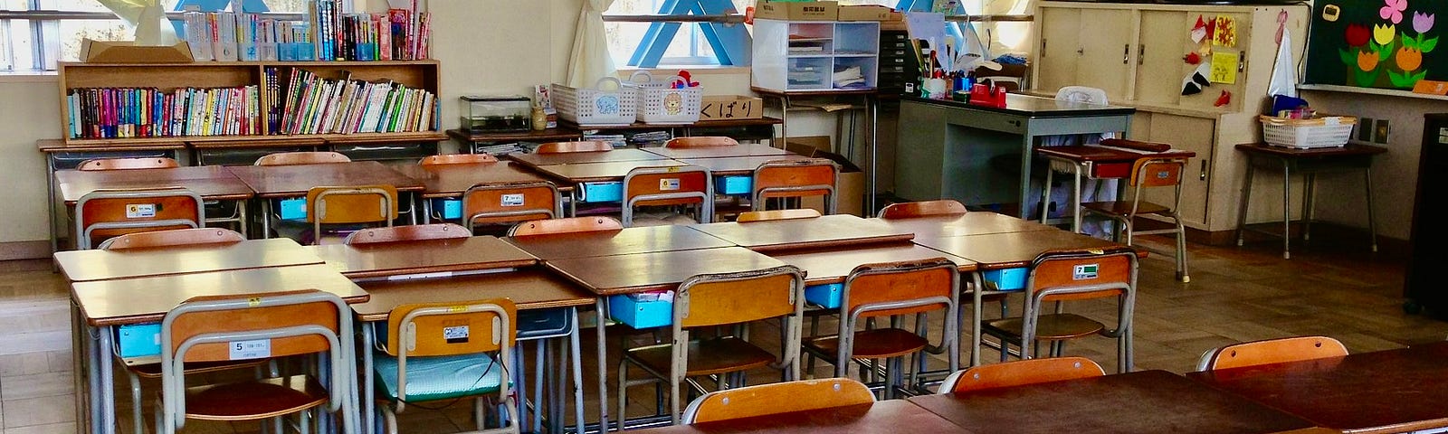 Japanese classroom, complete with clutter and wooden desks.