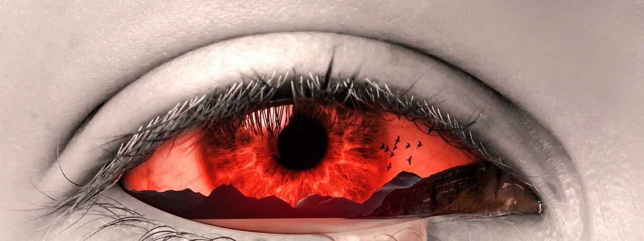 An single eye in horrid pain. The pupil and white of the eye a brilliant fire red and a solitary tear about to overflow.
