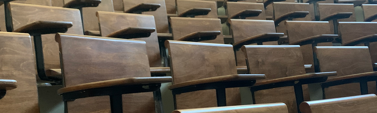 Rows of empty chairs in a lecture hall.