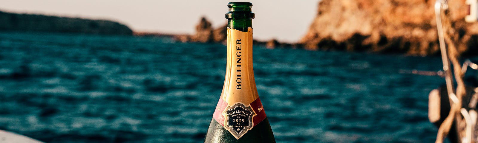 A bottle of Bollinger champagne on a boat. Photo by Sebastian Coman Photography : https://www.pexels.com/photo/bollinger-wine-bottle-on-boat-3461205/