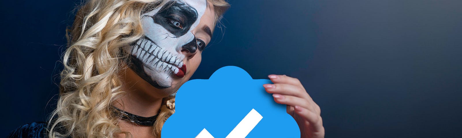 Woman in skeleton face paint holding Twitter verified icon.