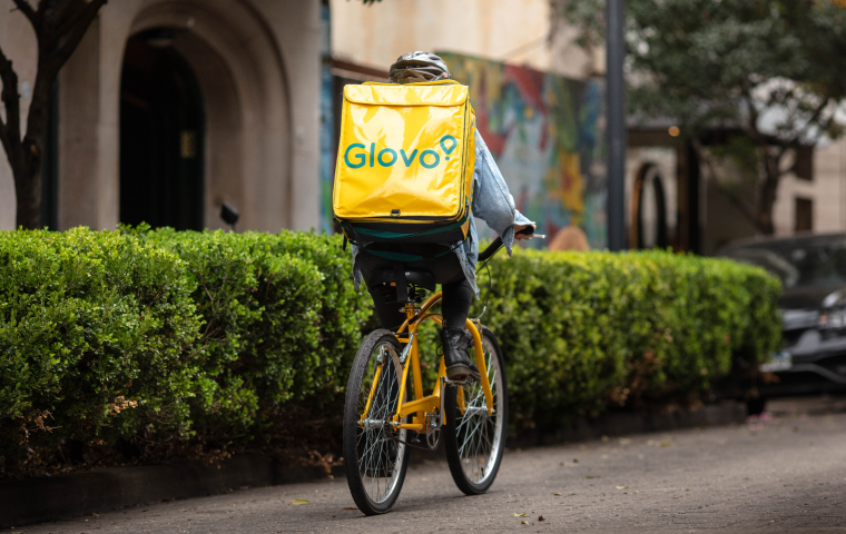 A Glovo rider on a bike