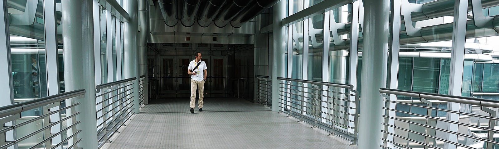 Man walking in hallway of empty office building