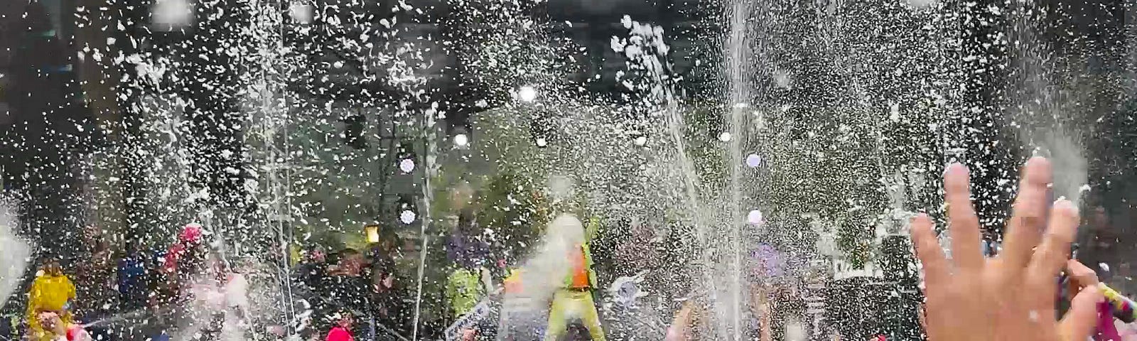 A foam-covered crowd dancing at the concert.