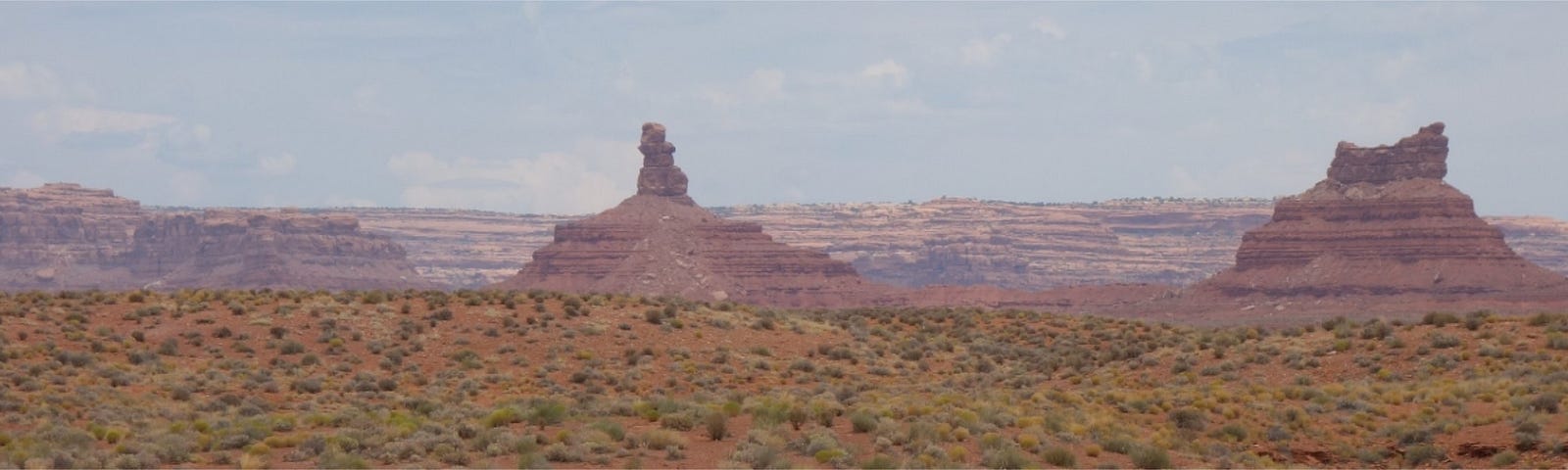 Two huge rock formations come out of the desert.