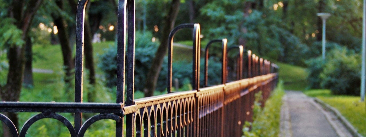 Iron fence around a large garden