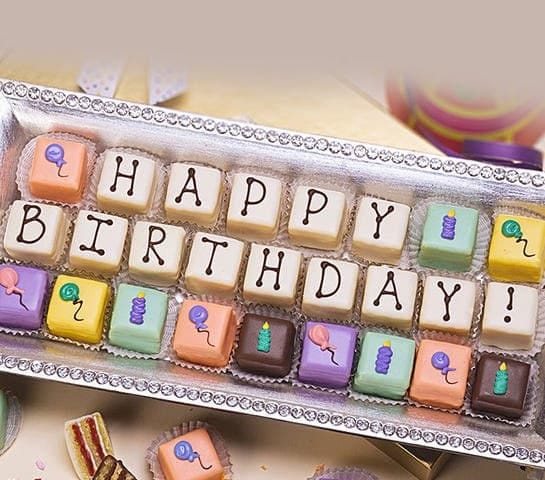 A box of small chocolate engraved with letters making up "Happy Birthday".