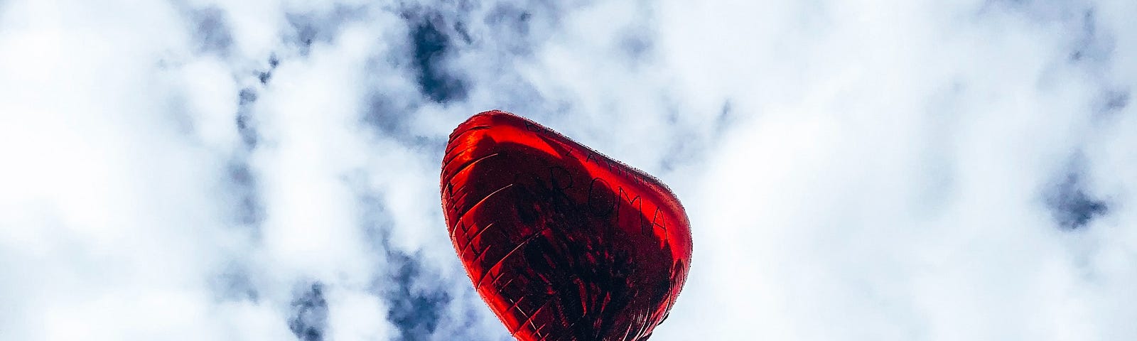 love/heart balloon floating away in the sky