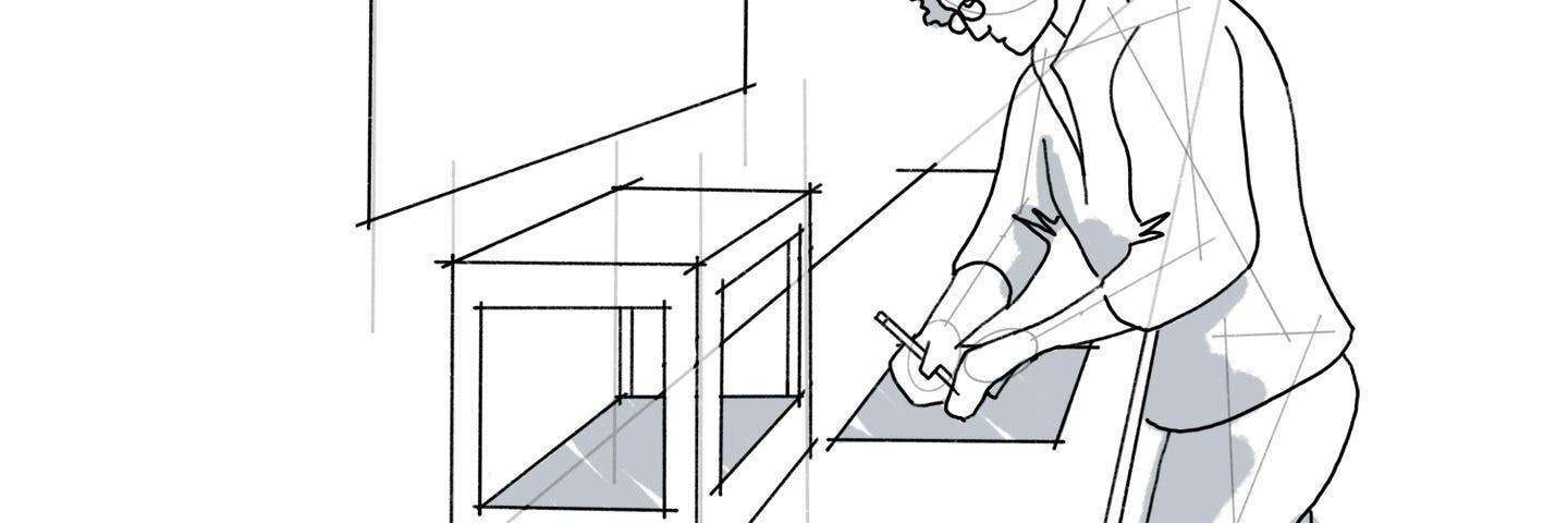 A line drawing of a person working at a workbench.