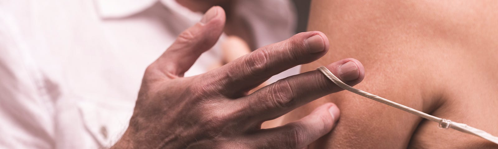 An older man undressing an older woman as they’re about to have sex