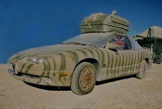 The desert-camouflage-themed art car at Burning Man, daytime view.