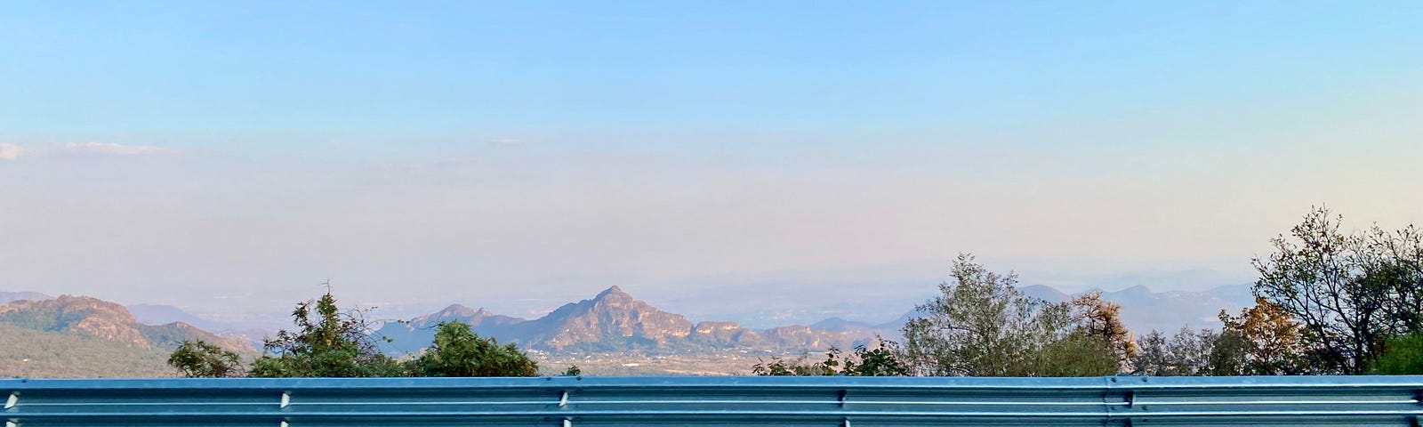 Road runs in parallel to the landscape, a metaphor for thought. Perspective of a mountain in the distance symbolizing vision