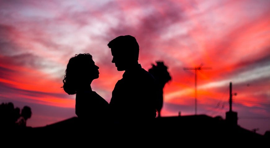 couple looking at each other in sunset