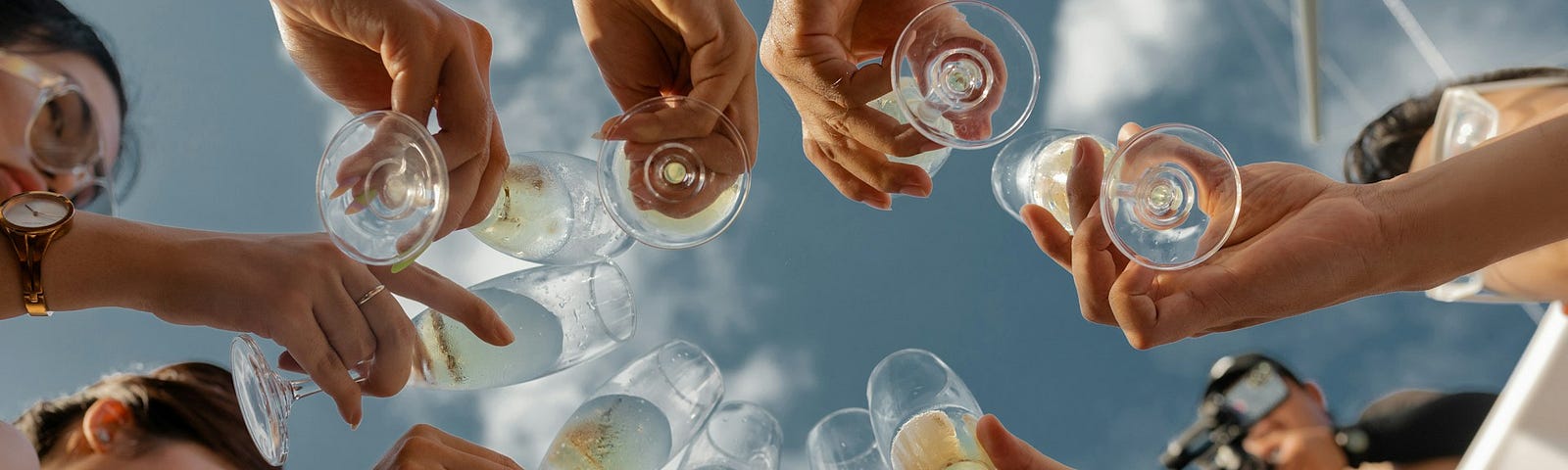 People raising champagne glasses to toast in a celebration