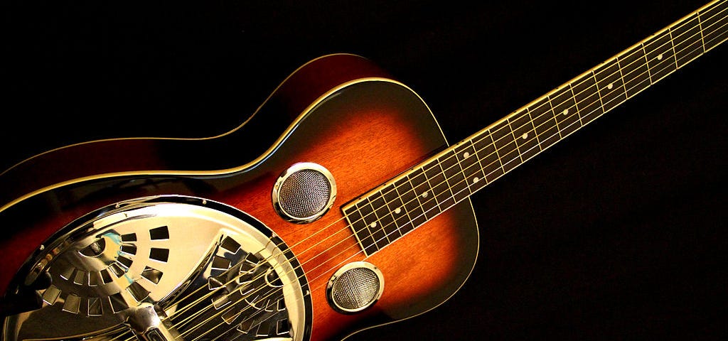 Wood and metal, gold tone resonator guitar