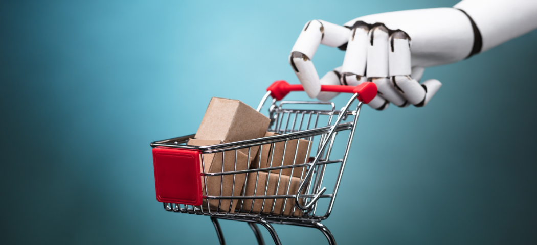 A large robotic hand pinches a tiny shopping cart filled with parcels.