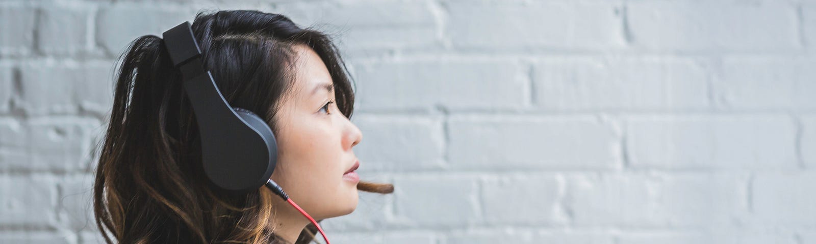 Side profile of an Asian woman with headset on