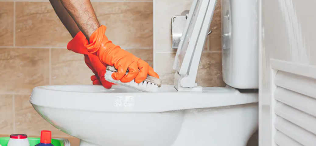 picture of guy choosing to clean the toilet instead of wash dishes