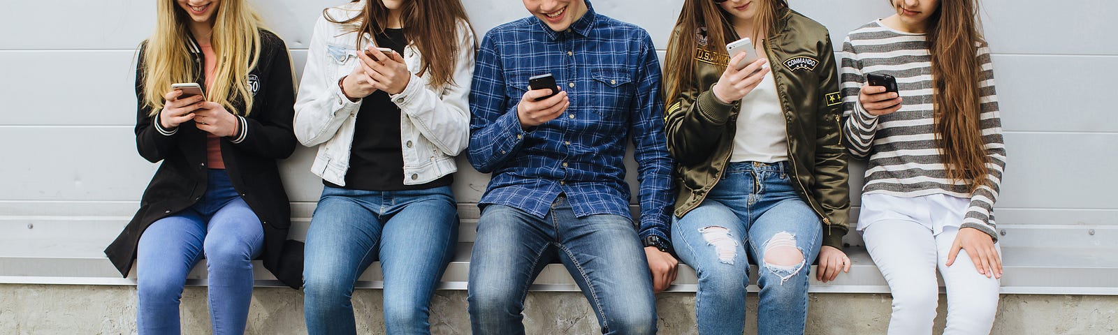 Group of teenagers outdoors with mobile phones