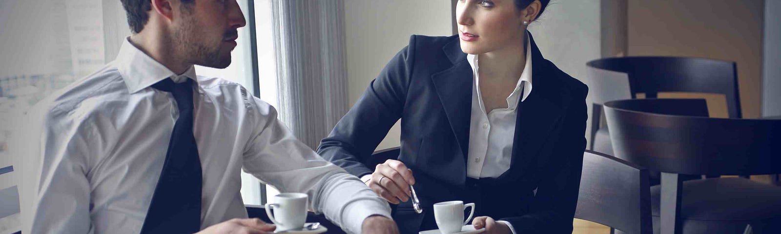 Business man and woman meeting over coffe