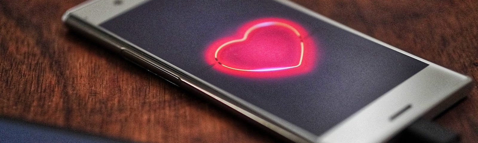 Two smartphones displaying bright red hearts.