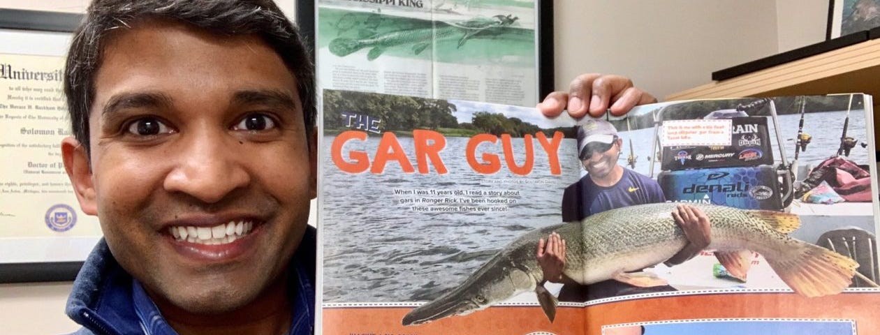 Solomon David holding up an issue of Ranger Rick featuring him and alligator gar