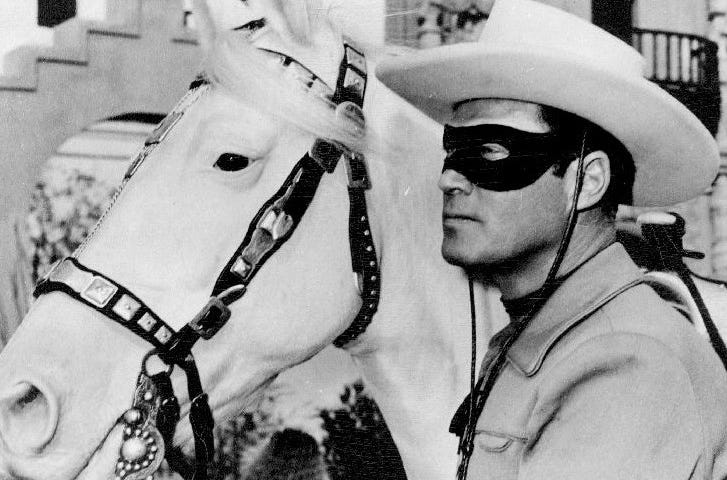 B&W Photo of Clayton Moore as the Lone Ranger next to his horse Silver