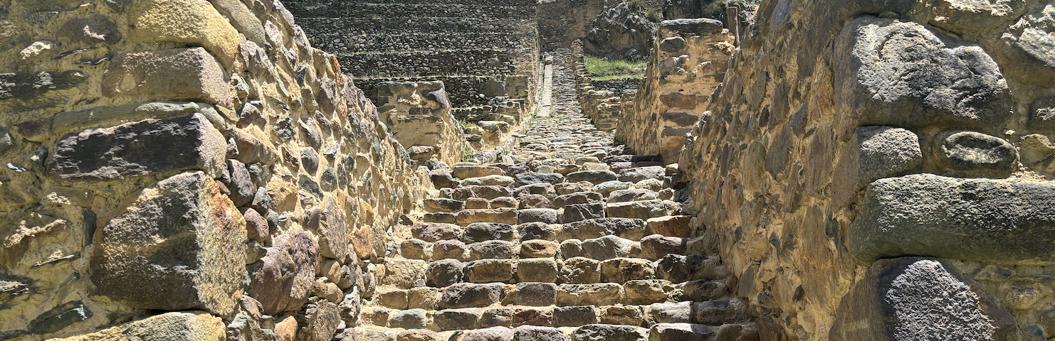 Ancient ruin in Ollantaytamba, Peru, reaching to the peak of the mountain. Stone walls and steps leading ever upwards.