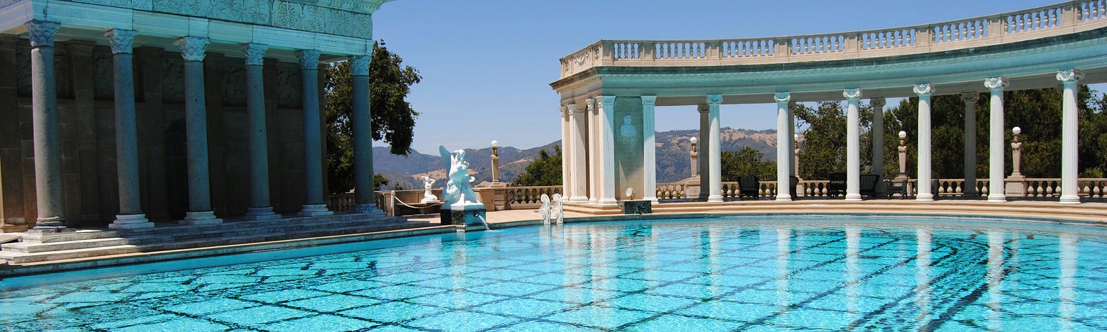 Image showing a large palace with marble columns and a massive swimming pool.