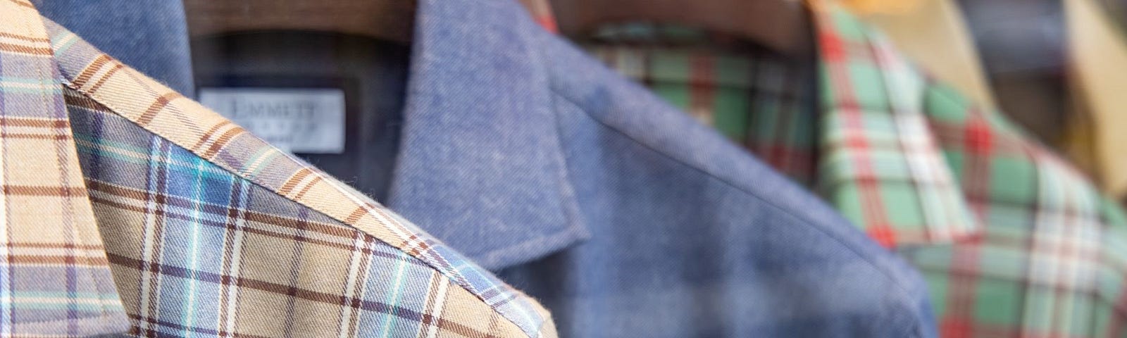 Flannel shirts hung on a rack.