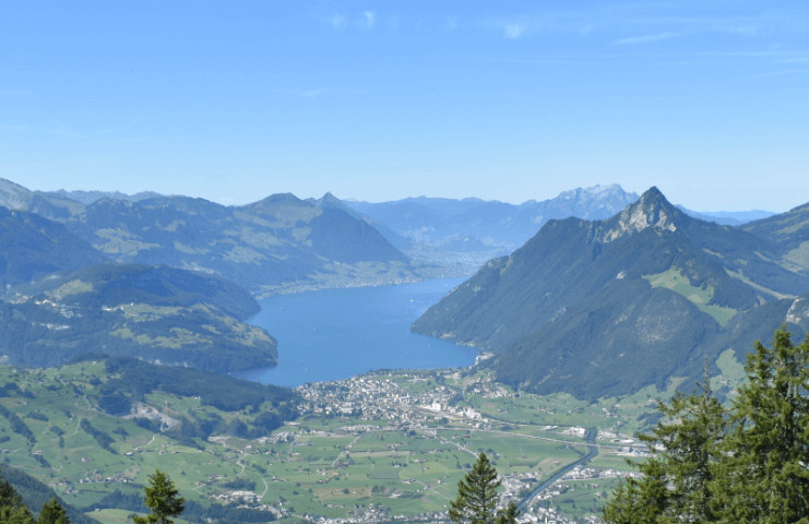 Long view of an alpine plain with a glacial lake and mountains — Moral Letters to Lucilius
