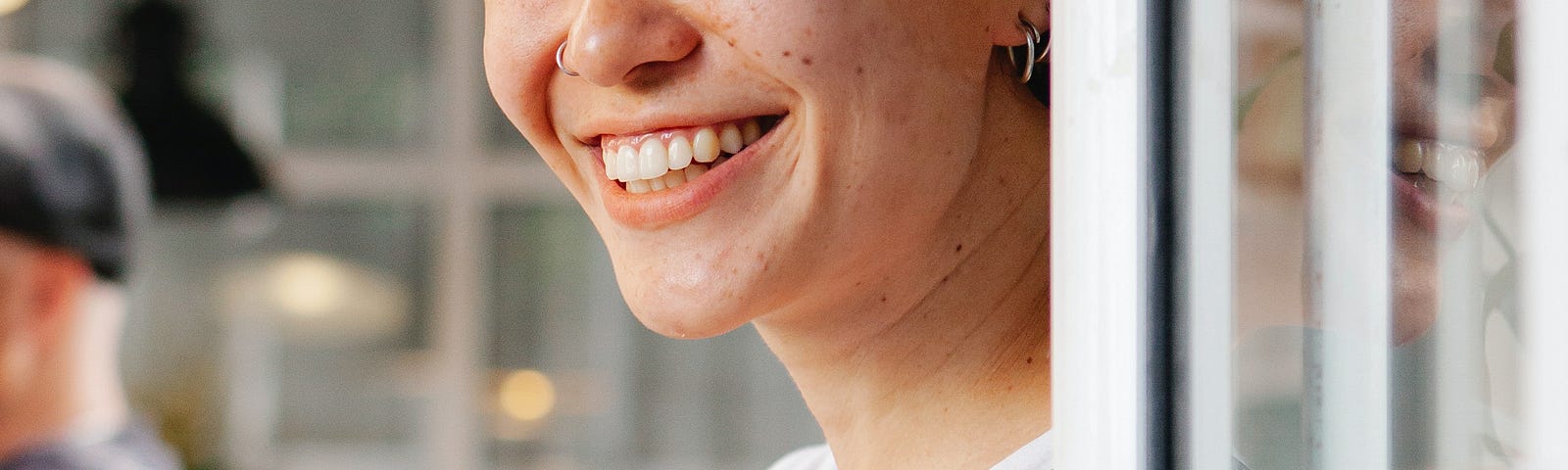 Woman with freckles, red hair, smiling