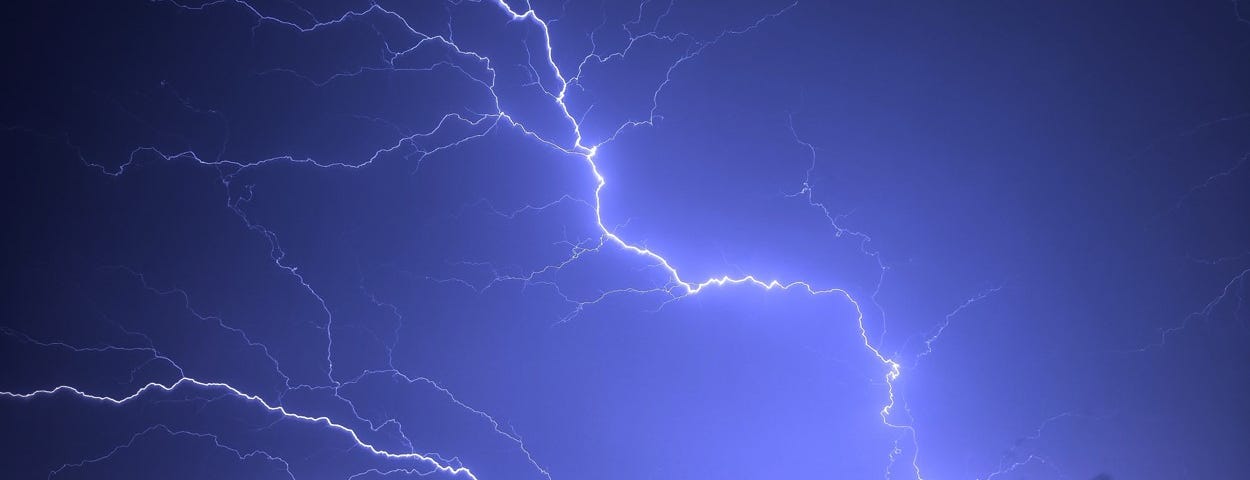 Thunderbolts illuminate the night sky, resembling the dark night of the soul the article discusses.