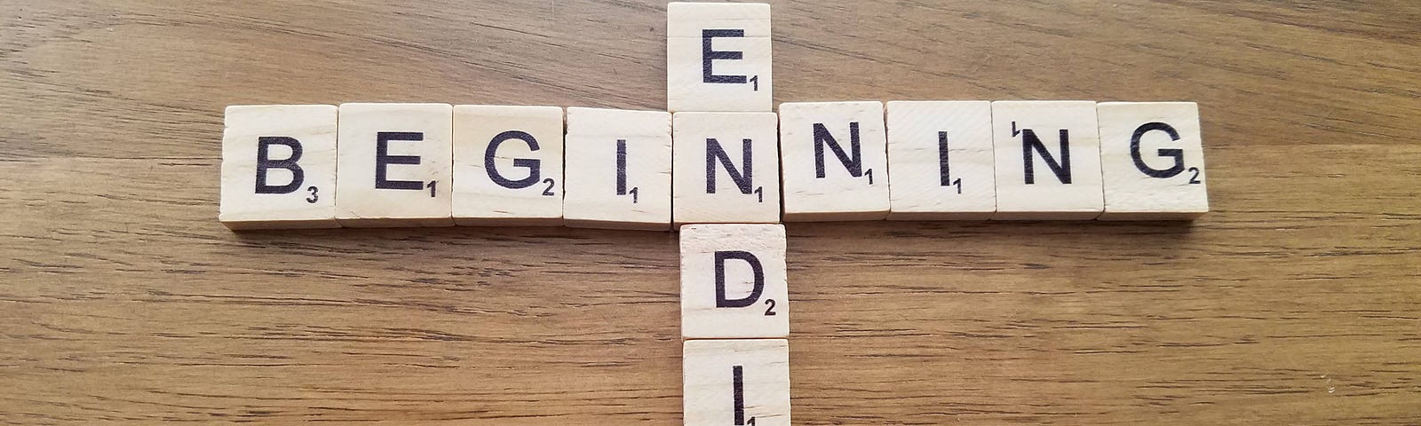 Wooden letters spelling out “beginning” (horizontally) and “ending” (vertically)