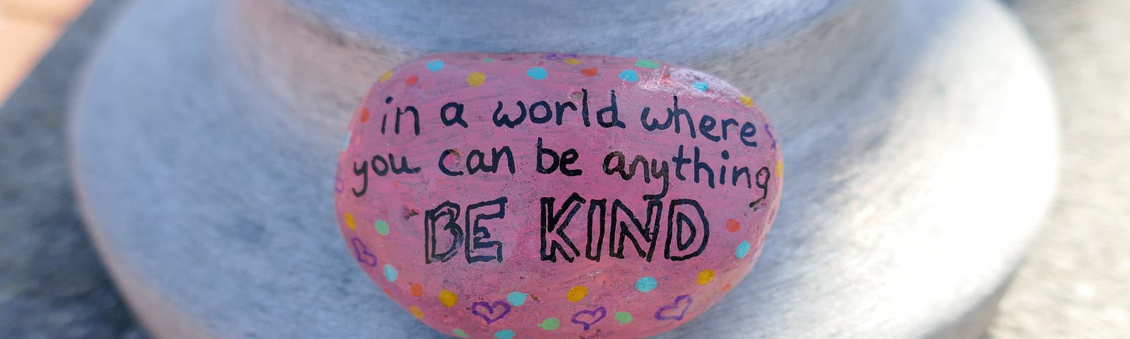 Be kind message painted onto pink kindness rock