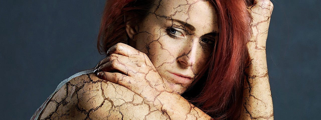 A sad, broken, woman. Her eyes showing her sorrow, her skin showing her cracks.
