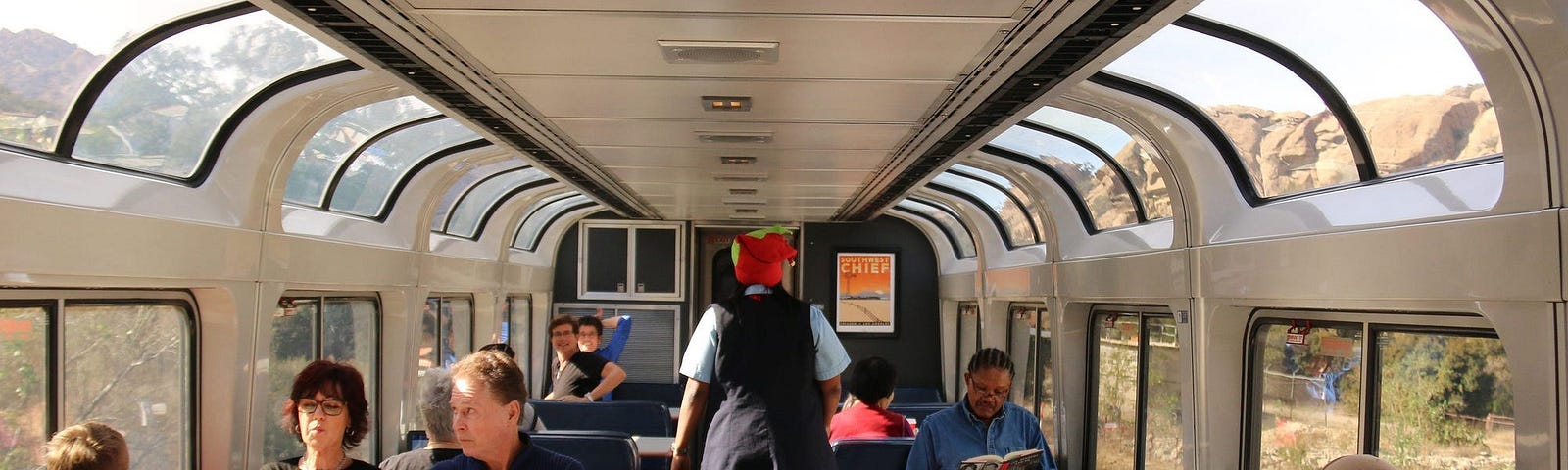 Inside an Amtrak train with passengers.