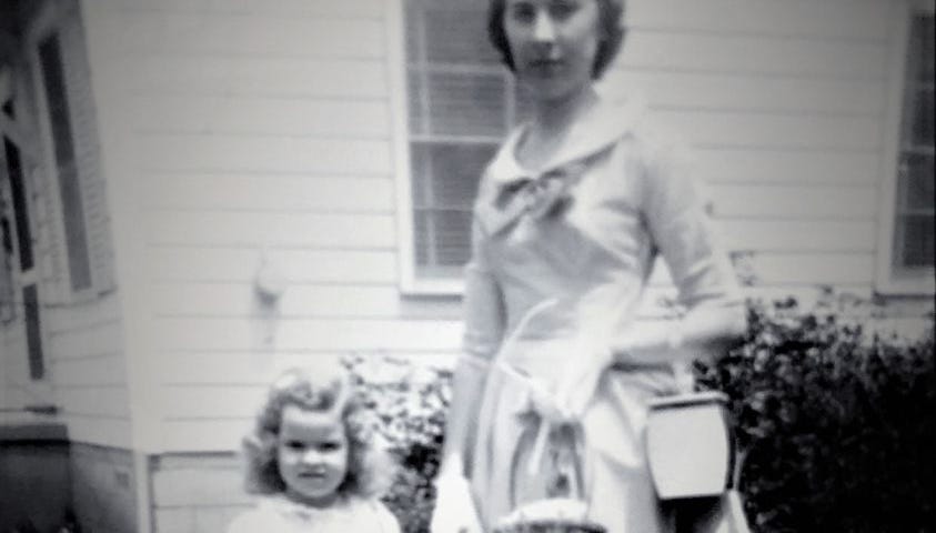 Black and white photo of author as a little girl holding the hand of her beautiful older sister Dot in the 1950s.