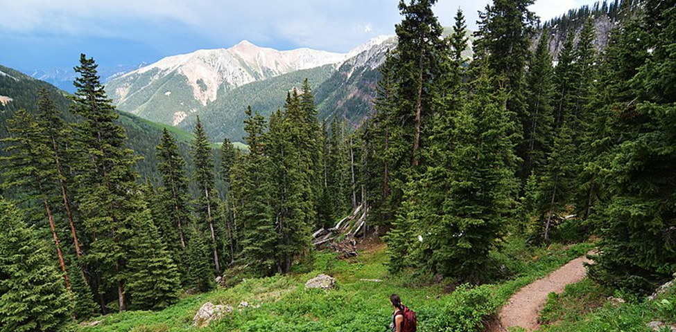 English Hiker ascends toward Lower Ice Lake Basin in Colorado’s San Juan National Forest. Author Paxson Woelber. This file is licensed under the Creative Commons Attribution-Share Alike 4.0 International license. File: Hiking to the Ice Lakes. San Juan National Forest, Colorado.jpg — Wikimedia Commons