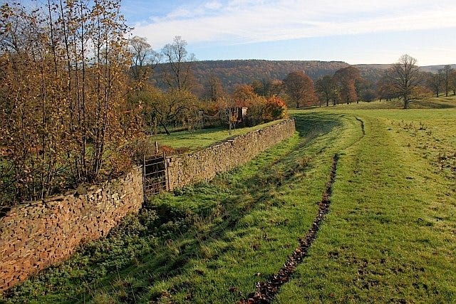 A ha-ha wall of stone in an English garden.