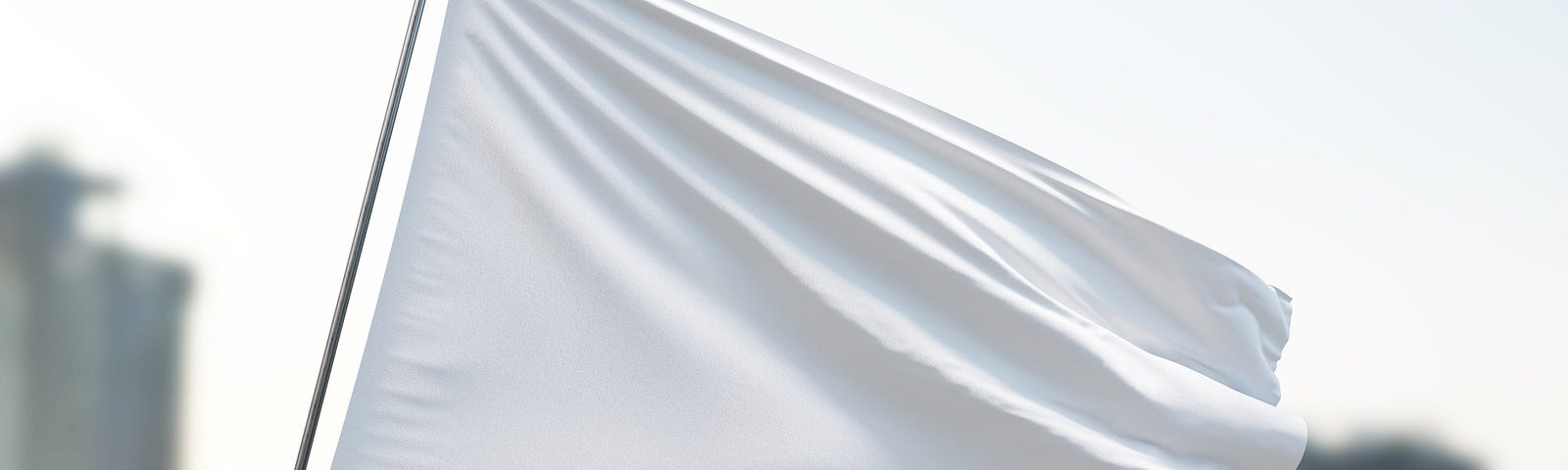 A white, surrender flag waving in the wind