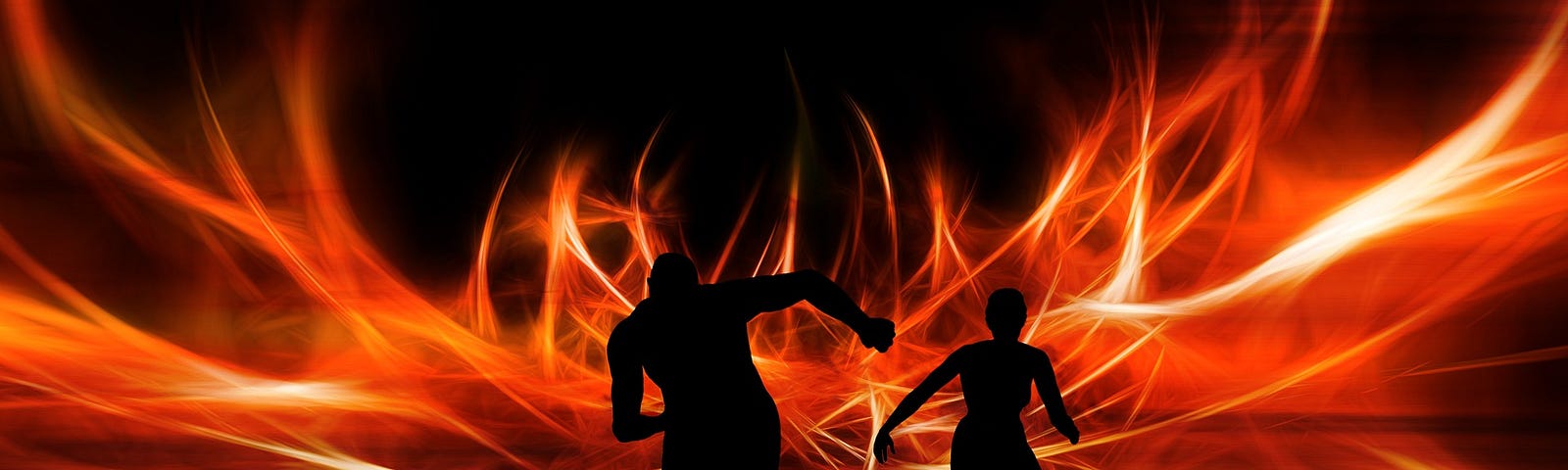 A silhouette of 2 people running away from a spreading fire.
