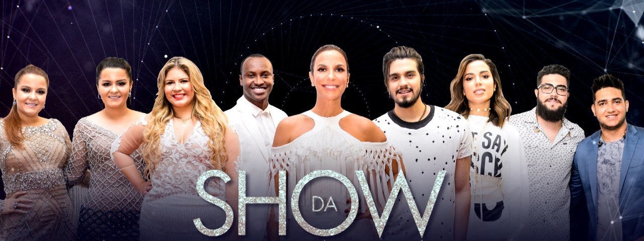 uma foto bem photoshopada, com os principais artistas do show da virada. Tem Anitta, ivete Sangalo, Luan Santana, Tiaguinho e umas duplas sertanejas. Todos de branco e sorrindo falsamente.