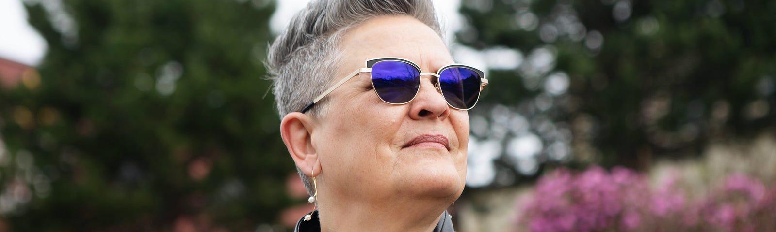 Older woman in a black leather jacket and sunglasses