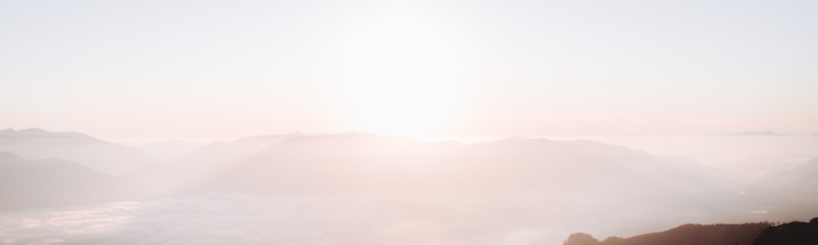 People sitting enjoying a sunrise and a beautiful view