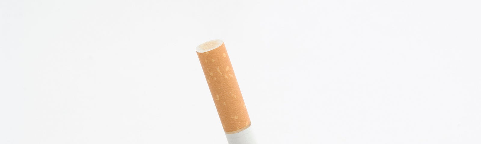 a cigarette being stubbed out into a pile of ash on a white background