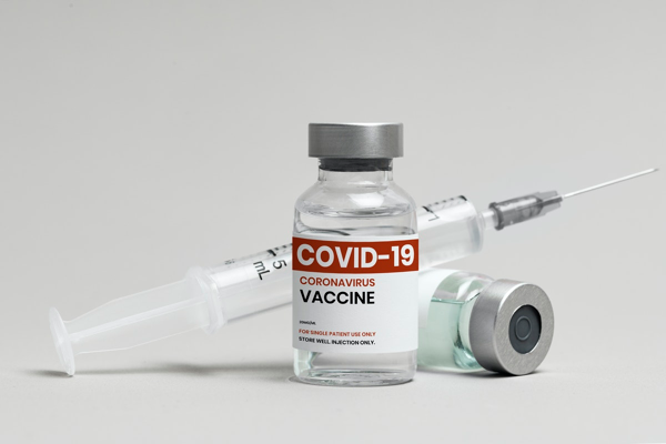 COVID-19 vaccine and injection needle